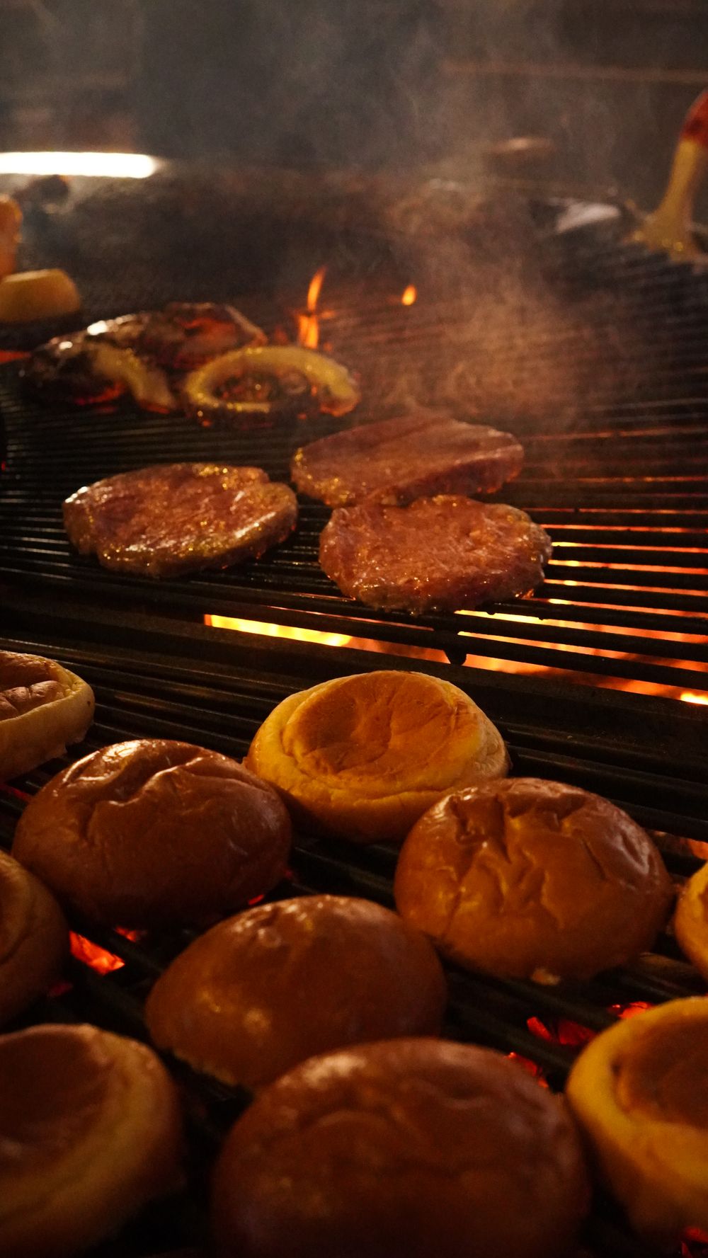 Burger patties and buns on the grill