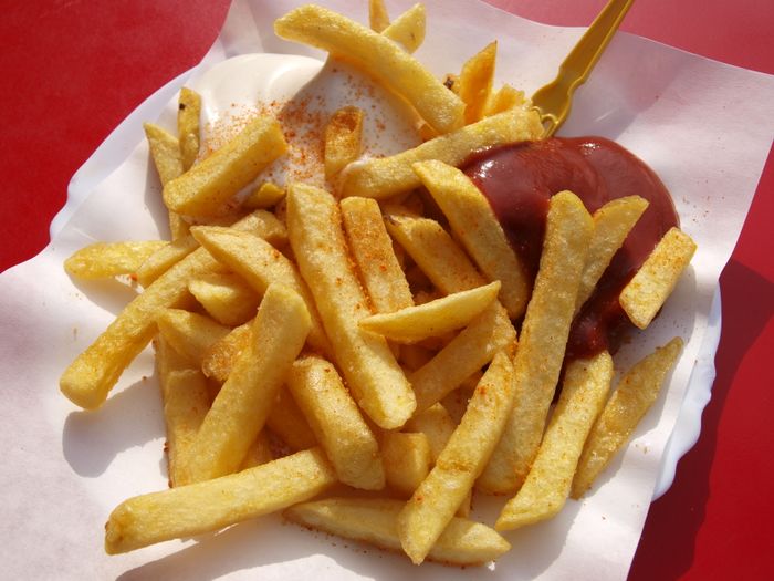 Golden fries spilling out of a paper bag
