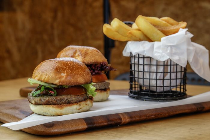 Burger and fries on a wooden board